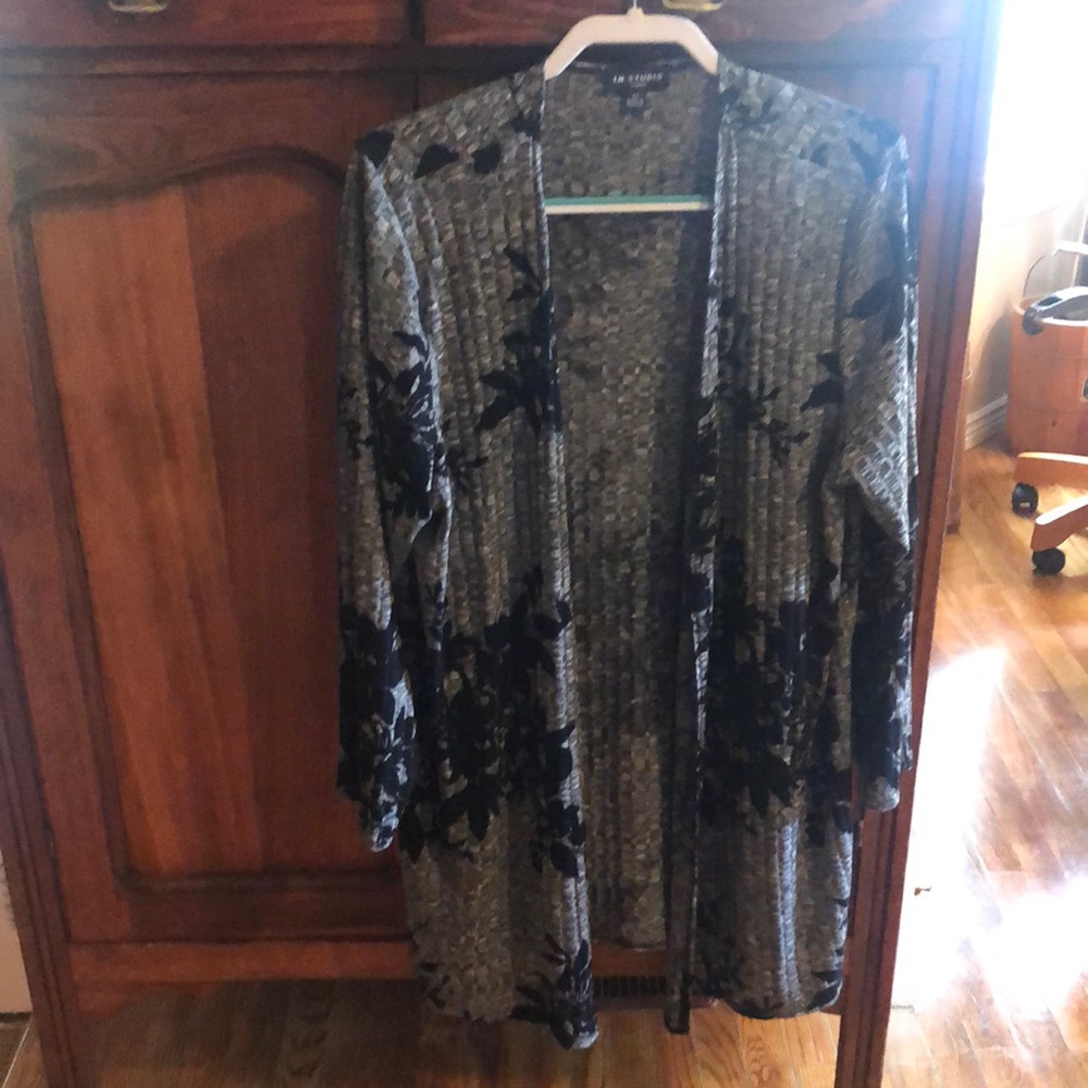Longer black and gray sweater with long sleeves. No buttons